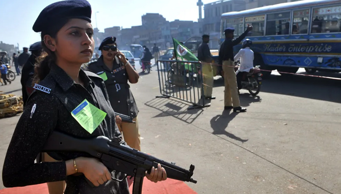 A representational image of a female police officer standing guard. — AFP/File