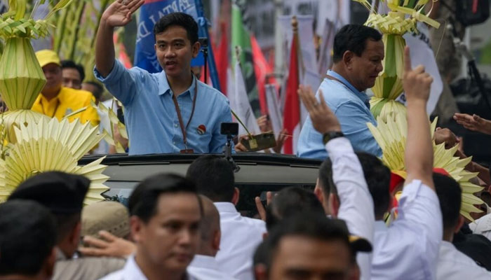 Presidential candidate Prabowo Subianto (R) and his running mate Gibran Rakabuming Raka (L) are considered the frontrunners