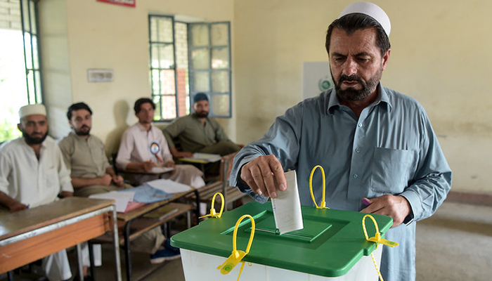 A voter casting a ballot in a polling station for the elections in Jamrud, in Khyber Pakhtunkhwa. — AFP/File