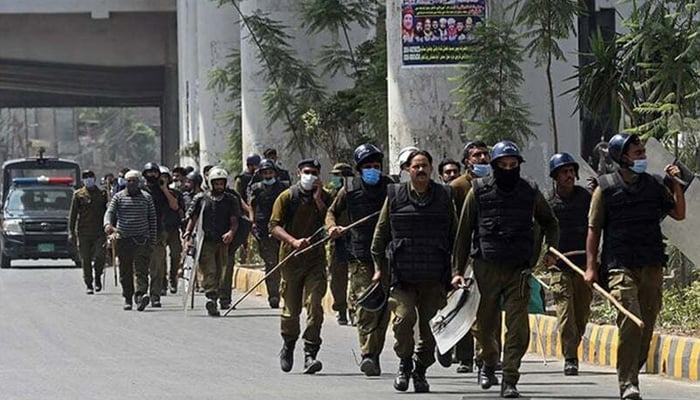 Punjab Police personnel walking on a road in Punjab. — AFP/File