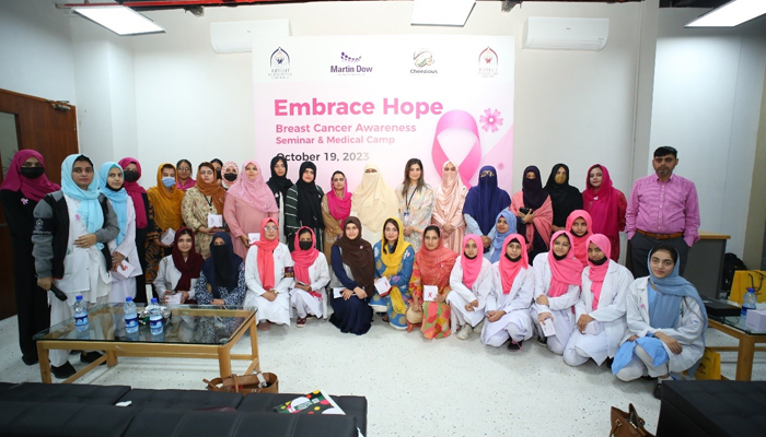 People can be seen gathered up for a group photo as Riphah International University holds a significant event at Gulberg Greens, Islamabad during Breast Cancer Awareness Month in this picture released on October 23, 2023. — Facebook/Riphah International University