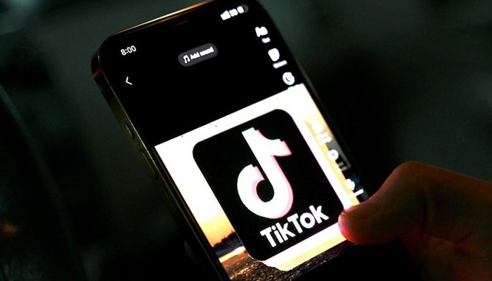 TikTok can be seen written with its logo on a phone screen. — AFP/File