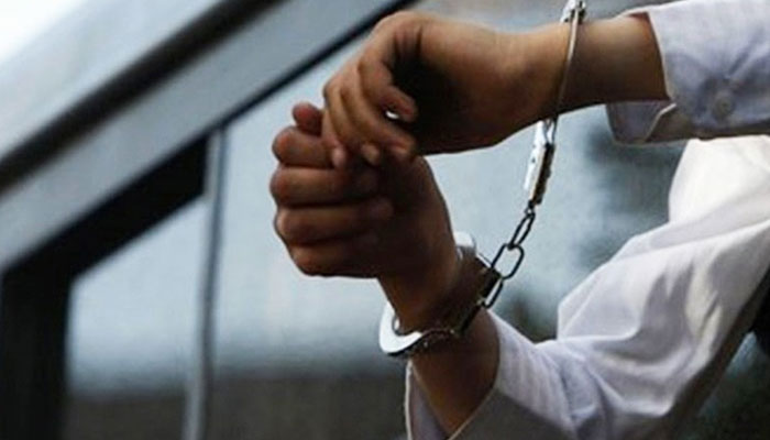 A representational image of a handcuffed man. — AFP