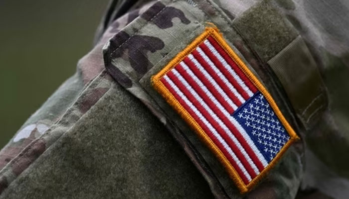A soldier of the US army wears the countrys flag on his uniform.(AFP)