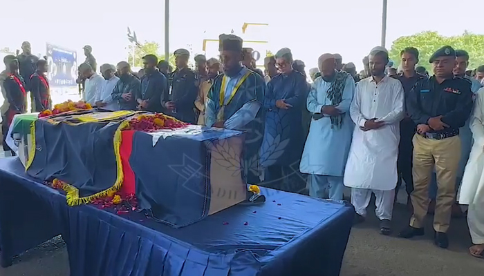 Police officials, among other attendees, can be seen offering a funeral prayer for the martyred SSU commando at the SSU Headquarters in this still taken from a video on October 28, 2203. — Facebook/Sindh Police