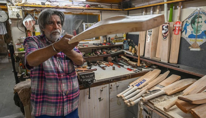 Aslam Chaudhry, a bat-maker and fixer, who frequently comes to the rescue of crickets most recognisable stars out of his small, decades-old workshop in south Mumbai, India. — AFP/File