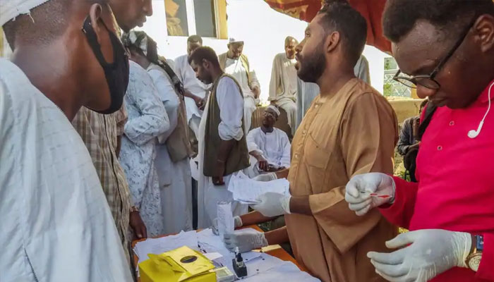 People queue at a medical laboratory to get tested for dengue fever in the eastern Gedaref state of Sudan, Sept. 22, 2023. — AFP
