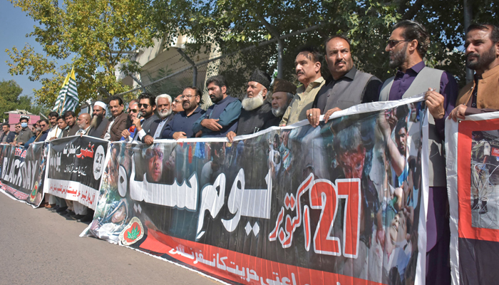 Activists of All Parties Hurriyat Conference (APHC) hold a banner during a protest on the occasion of Black Day against Indias landing of troops in Occupied Kashmir, outside Shamas gate in Islamabad on October 27, 2023. — Online