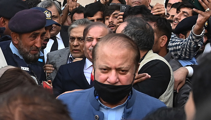 Former Prime Minister and graft convict Nawaz Sharif (C) leaves after appearing before the High Court in Islamabad on October 24, 2023. — AFP