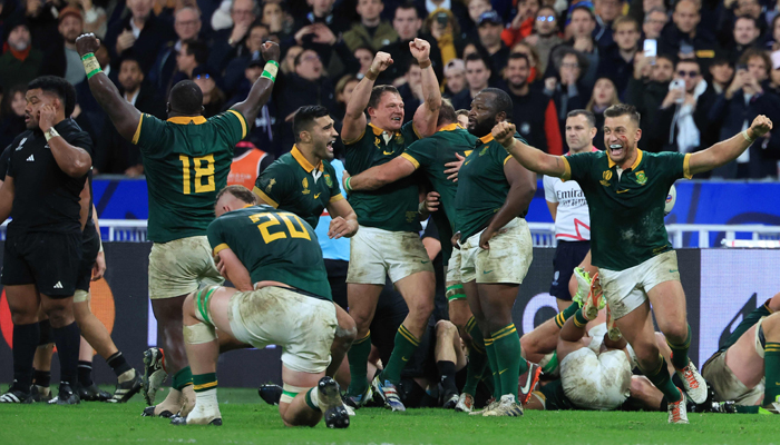 South Africas fly-half Handre Pollard (R) lifts his hands in the air as South Africas players celebrate winning the France 2023 Rugby World Cup final match against New Zealand at the Stade de France in Saint-Denis, on October 28, 2023. — AFP