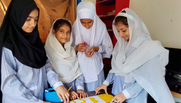 Students of Roshan Pakistan School can be seen during a learning activity in the school in this picture released on September 14, 2023. — Facebook/Roshan Pakistan School