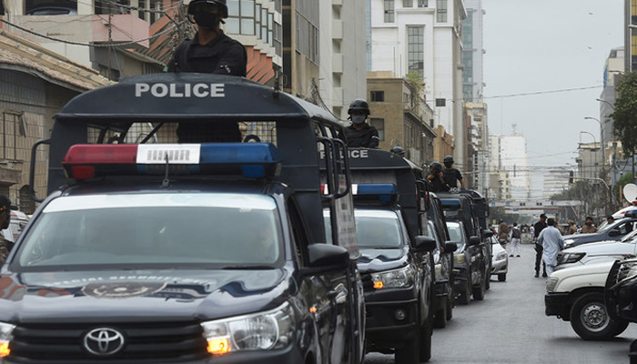 Policemen patrol near the Pakistan Stock Exchange building following an attack in Karachi. — AFP/File