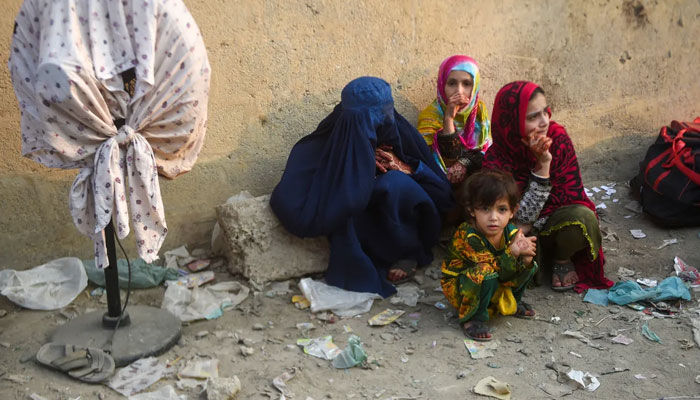 Afghan refugees wait at the Karachi bus terminal in Sindh province to depart for Afghanistan. — AFP/File