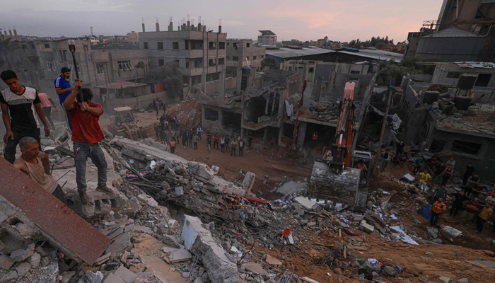 Palestinians search for survivors in the rubble of a building in the Nuseirat refugee camp, in the central Gaza Strip on October 31, 2023. — AFP