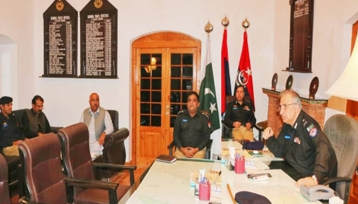 KP IGP Akhtar Hayat Khan (right) looks on as other officers and people sit in his office in this image released on November 1, 2023. — Facebook/Khyber Pakhtunkhwa Police