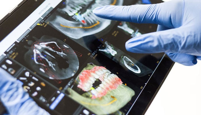 A representational image of a doctor using a tablet. — Unsplash