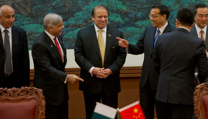 The then-Chinese Premier Li Keqiang (third from right) gestures near the then-PM Nawaz Sharif (centre) and Shahbaz Sharif (second from left) before a signing ceremony at the Great Hall of the People in Beijing. — AFP/File