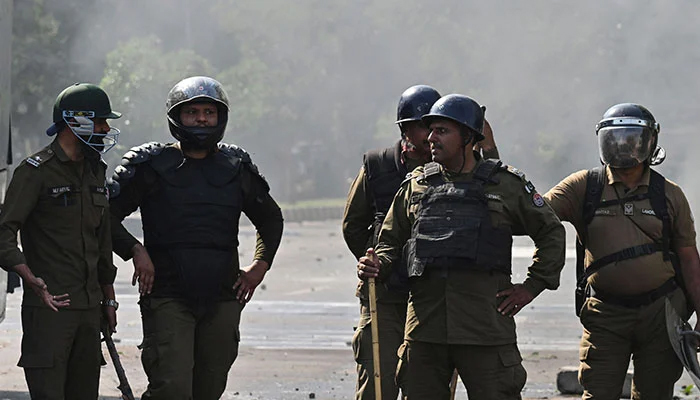 Policemen stand guard during a protest in Lahore on May 11, 2023. — AFP