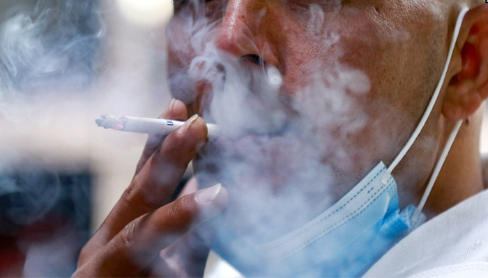 A representational image shows a person smoking. — AFP/File