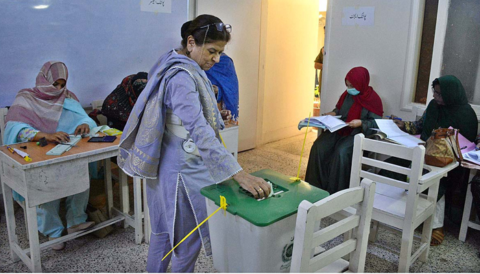 A female voter exercising her right to vote at a polling station in the metropolis during by-elections for direct LG seats on November 5, 2023. — APP