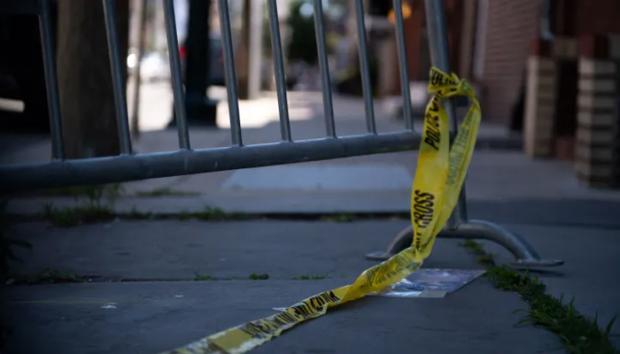 Police tape hangs from a barricade. — AFP/File