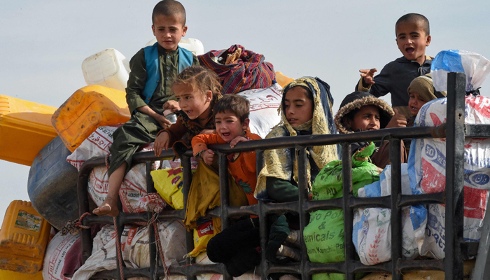 In this photo taken on November 4, 2023, Afghan refugee children along with their belongings arrive at the Chaman border to depart for Afghanistan. — AFP