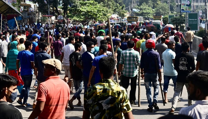 Garment workers block a road during a protest demanding the increase of their salaries, in Dhaka on November 2, 2023. — AFP