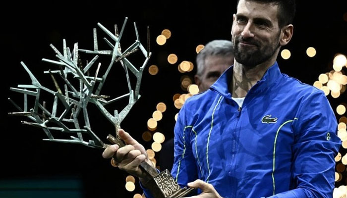 Novak Djokovic celebrates with the trophy after completing the French Open and Paris Masters double for the second time in three years. — AFP Flie
