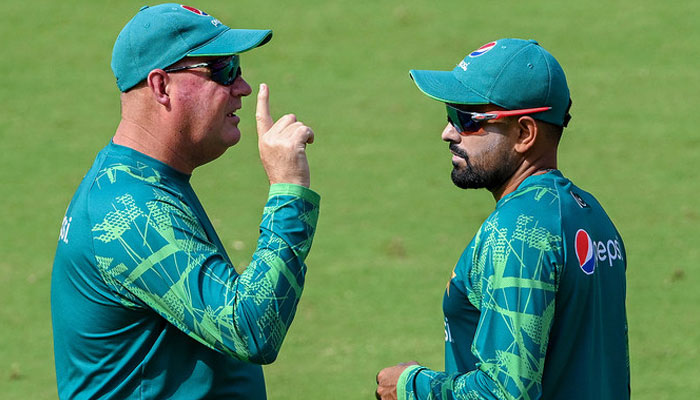 In this file photo, taken on October 13, 2023, Pakistan’s captain Babar Azam (R) talks with team director Mickey Arthur during a practice session for 2023 ICC Mens Cricket World Cup one-day international (ODI) match in Ahmedabad. — AFP