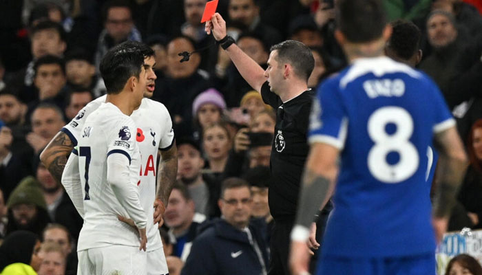Michael Oliver shows a red card to Tottenhams Cristian Romero. — AFP