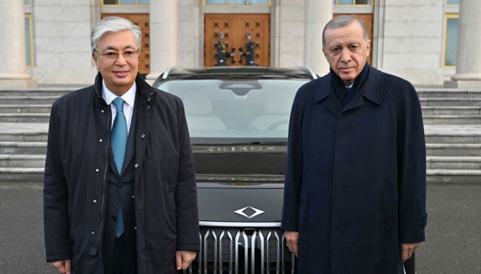 In this handout photograph taken and released by Kazakhstan’s Presidential Press Service on November 3, 2023, Turkey’s President Recep Tayyip Erdogan (R) poses with Kazakhstan’s President Kassym-Jomart Tokayev (L) after presenting him a Turkish-made TOGG electric car, on the sideline of the 10th Summit of the Heads of State of the Organization of Turkic States (OTS), in Astana. — AFP
