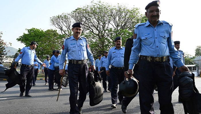 Police officers arrive to deploy outside the Parliament House building in Islamabad. — AFP/File