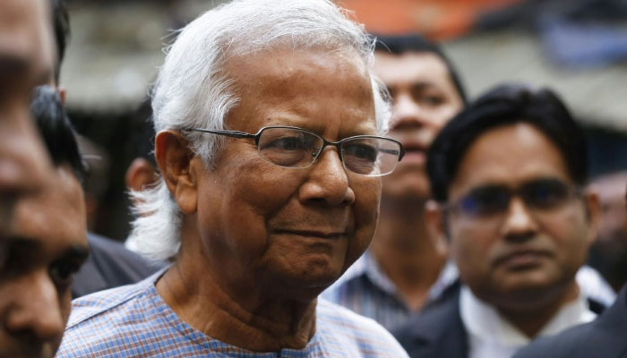 Nobel peace laureate Muhammad Yunus arrives with his lawyers for a court hearing in a labour law case in Dhaka. — AFP File
