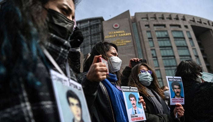 Members of Saturday Mothers gather holding pictures of disappeared revalitives on March 25, 2021 in front of the Caglayan courthouse before their trial in Istanbul. — AFP File