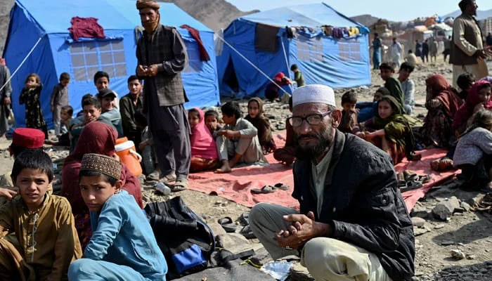 Afghan refugees rest at a makeshift camp upon their arrival from Pakistan, near the Afghanistan-Pakistan Torkham border in Nangarhar province on November 2, 2023. — AFP