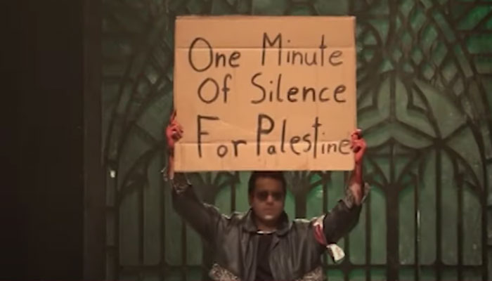 A man is seen holding a pro-Palestine placard during a fashion show in Karachi, in this still taken from a video. — Instagram/@irfanistan
