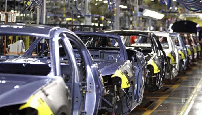 A representational image showing partly finished vehicles at a manufacturing plant. — APP/File