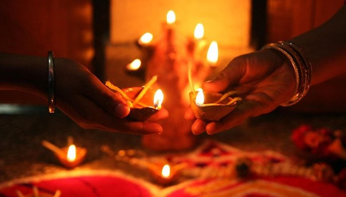 People light up lamps dring Diwali. — AFP/File