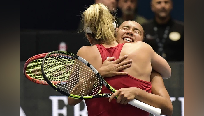 Gabriela Dabrowski and Leylah Fernandez celebrate after beating Barbora Krejcikova and Katerina Siniakova during the semifinal doubles match at the Billie Jean King Cup in La Cartuja stadium in Seville on November 11, 2023. — AFP