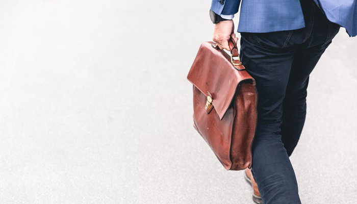 This representational image shows a person walking with a bag. — Unsplash/File