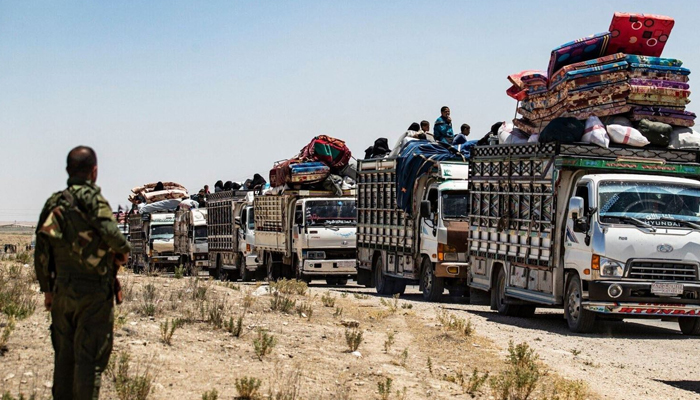 This image shows people on the trucks leaving. — AFP