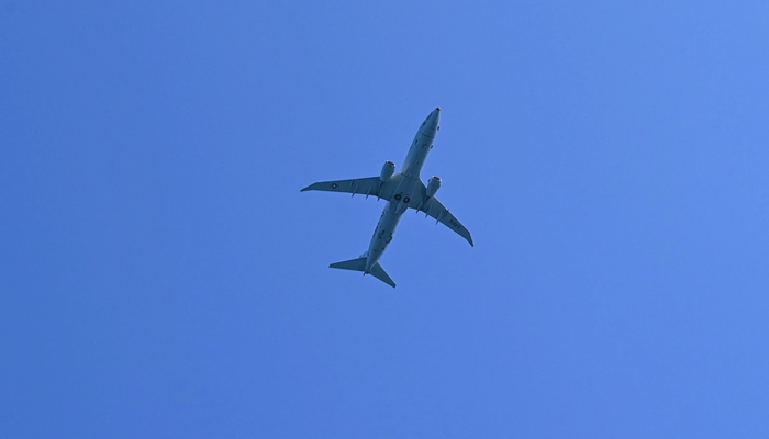 This shows a US Navys P-8 Poseidon patrol and reconnaissance plane circling during a Philippine coast guards mission in the South China Sea on November 10, 2023. — AFP
