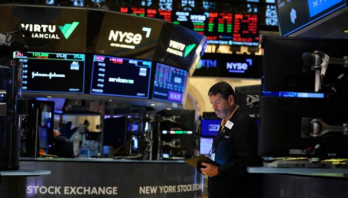 A person uses a device in the New York Stock Exchange in this image. — AFP/File