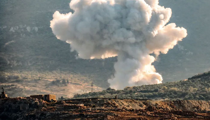 A plume of smoke rises above hills in the rebel-held northwestern Idlib governorate. — Muhammad Haj Kadour/AFP