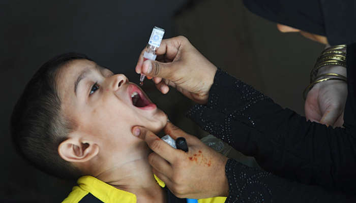 A Pakistani child receives polio vaccine drops during a polio vaccination campaign. — AFP/File