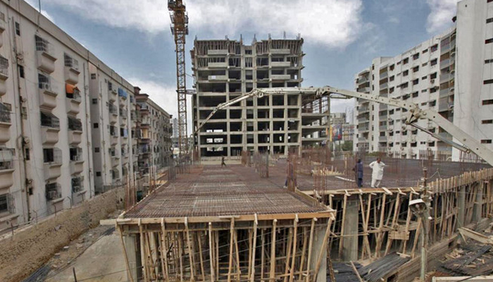 A representational image showing labourers working on a building construction site. — AFP/File