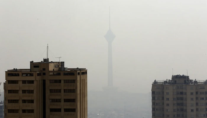 The Milad telecommunications tower behind smog in Tehran, November 16, 2016. — EPA