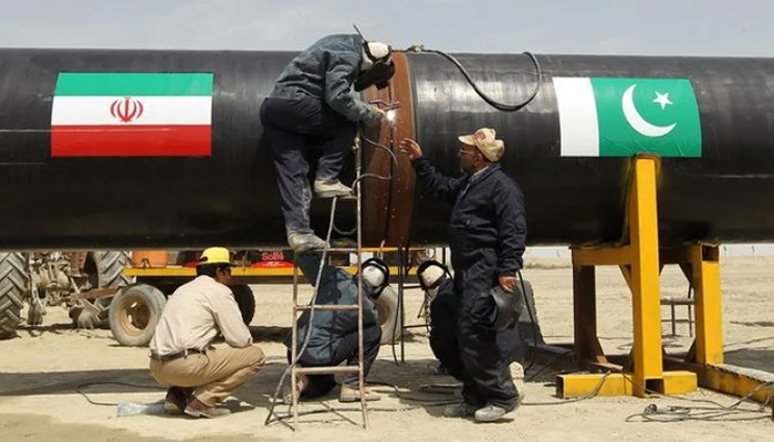 Workers can be seen busy working on a gas pipeline at Chah Bahar, Iran. — AFP/File