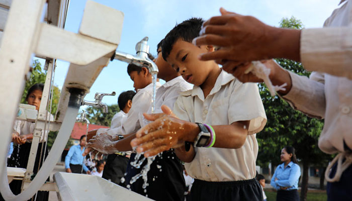 Students wash their hands at a local school. KT/Tep Sony