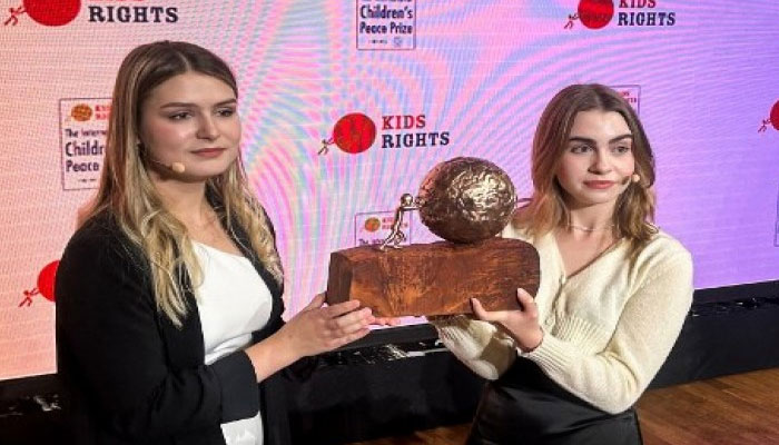 Ukraine’s Anastasiia Feskova (L) and Ukraine’s Sofia Tereshchenko (R) pose with the trophy after being awarded the 2023 KidsRights International Children’s Prize during a ceremony, in London, on November 17, 2023.  — AFP File